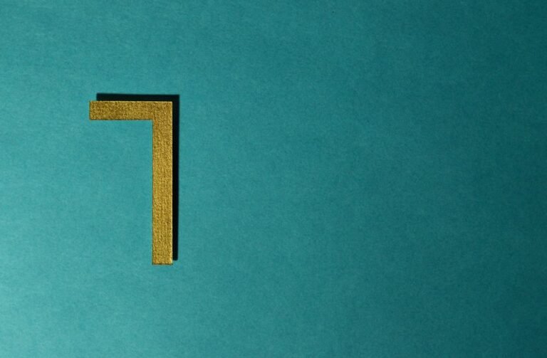 Chiffre 7 doré sur fond bleu-vert texturé, symbole de numérologie